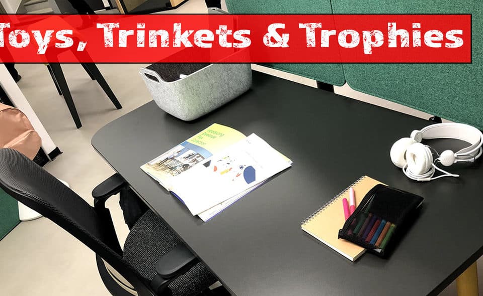 Office desk setup featuring books and headphones, ideal for nurturing talent and career growth. Perfect for leadership insights from a renowned author in HR.