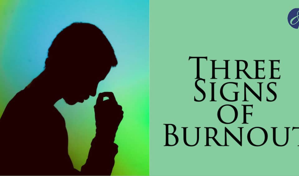 A silhouette of a person looking stressed, highlighting "Three Signs of Burnout" to explore work-life balance challenges in career, leadership, and HR.