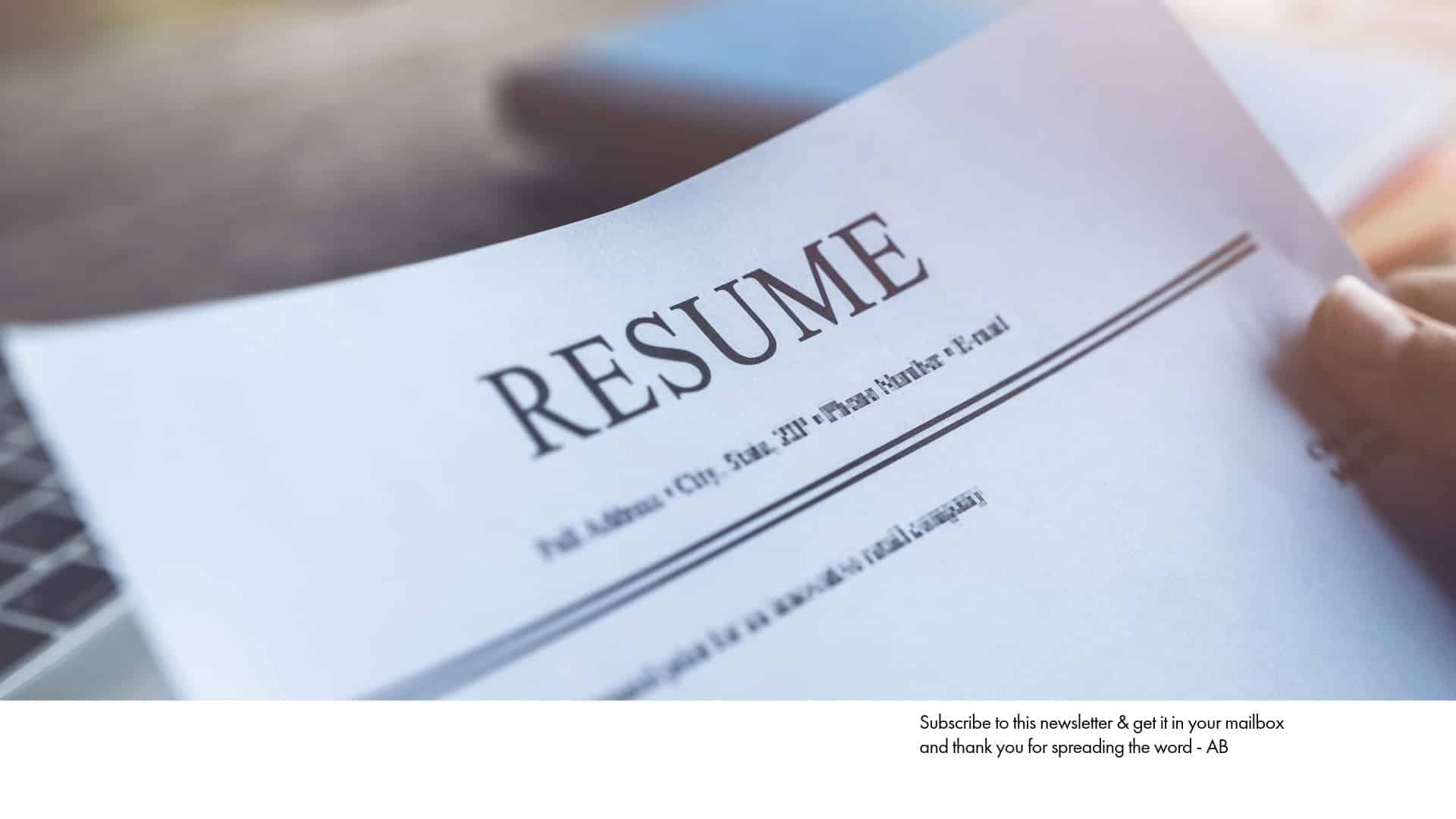 Close-up of a person holding a resume. Your resume is a signaling device; make sure you're sending the right signals with a well-crafted document.