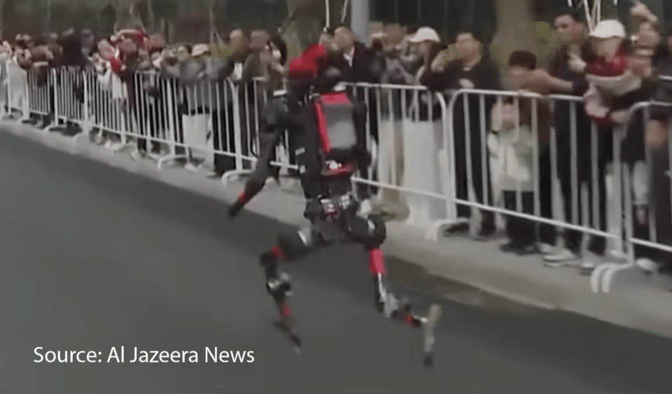 A humanoid robot races past a cheering crowd, showcasing AI robotics that enhance creative job opportunities.